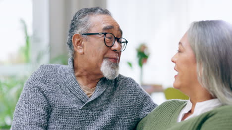Senior-couple,-happy-and-talking-in-living-room