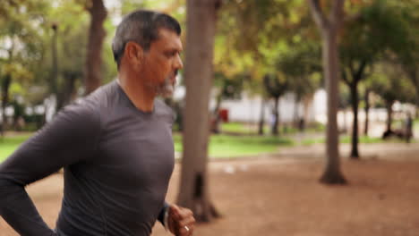 Mature-man,-running-and-outdoor-park-with-athlete