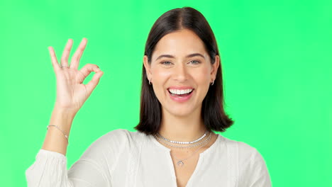 Okay-hands,-face-and-happy-woman-on-green-screen