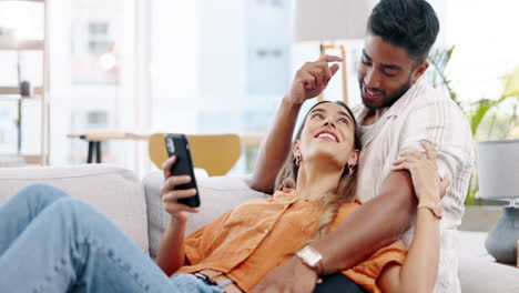 Couple,-phone-and-relax-on-couch-with-social-media