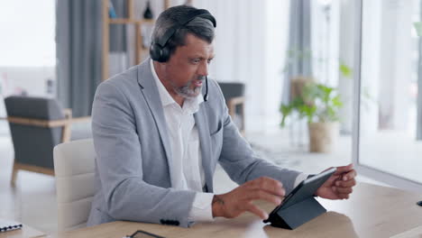 Businessman,-tablet-and-headphones-consulting