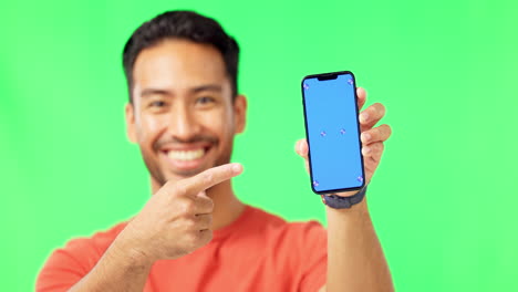 Asian-man,-phone-and-pointing-to-mockup-on-green