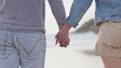 Back,-holding-hands-and-a-couple-at-the-beach