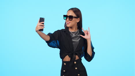 Selfie,-sunglasses-and-woman-with-rock-sign