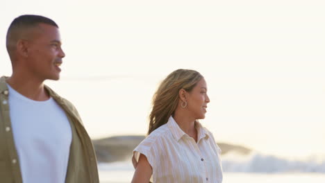 Beach,-love-and-couple-at-sunset-walking-together