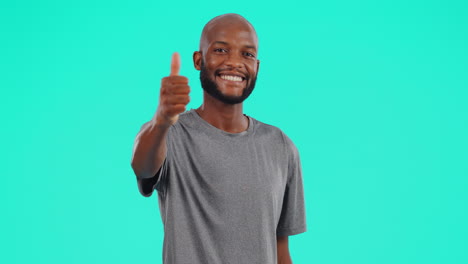 Face,-smile-and-black-man-with-thumbs-up-in-studio