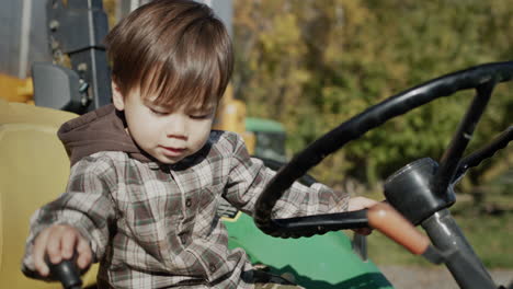 A-small-tractor-driver-at-the-wheel-of-a-tractor,-intensively-turns-the-steering-wheel-and-pulls-the-lever