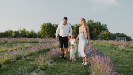 Cheerful-family-with-two-children-walking-in-the-lavender-field