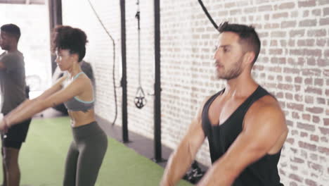 three-people-using-kettle-bells--while-working-out