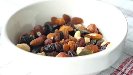 Slow-motion-of-mixed-nuts-dropping-in-a-bowl