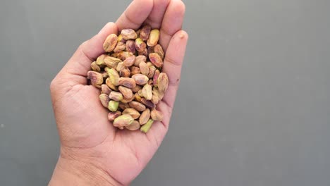 Close-up-of-pistachios-nut-on-hand