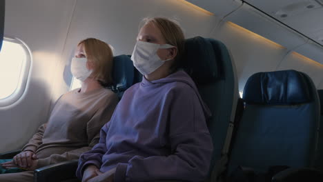 Families-in-protective-masks-during-a-long-and-tiring-flight