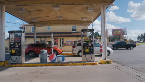 Lockport,-NY,-USA,-October-2010:-Cars-are-refueled-at-a-duty-free-gas-station.-A-Native-American-poster-is-visible-in-the-background.