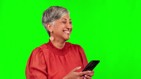 Phone,-typing-and-senior-woman-on-green-screen