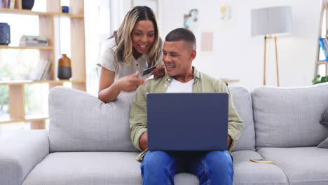 Home,-laptop-and-couple-with-a-credit-card