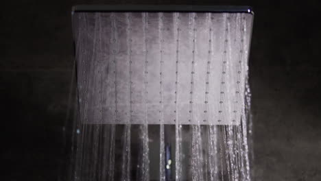 Jets-of-water-flow-from-the-square-shower-head.-Elite-plumbing-and-comfort,-slow-motion-video