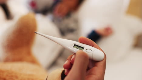 Hand,-thermometer-and-closeup-for-kid-with-fever