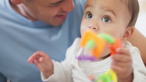 Father,-baby-or-child-with-a-toy-in-mouth