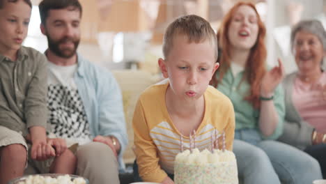 Boy-blowing,-birthday-party