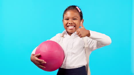 Happy,-sports-and-child-with-a-thumbs-up-on-a-blue