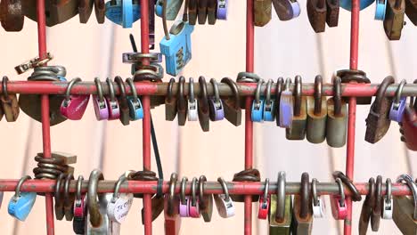 Many-love-padlocks-locked-on-rusty-iron-gate-in-singapore-,