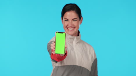 Woman,-phone-and-smile-by-green-screen-in-studio