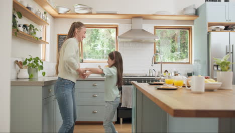 Dance,-happy-and-mother-with-daughter-in-kitchen