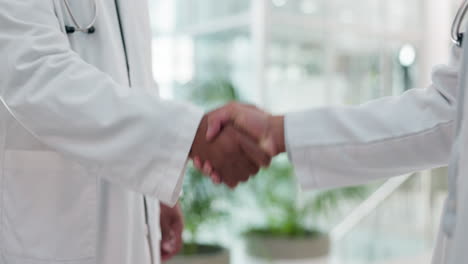 Teamwork,-healthcare-and-doctors-shaking-hands
