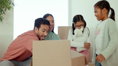 Parents,-children-and-open-box-in-new-house