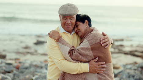 Senior-couple,-love-and-hug-at-the-beach-for-care