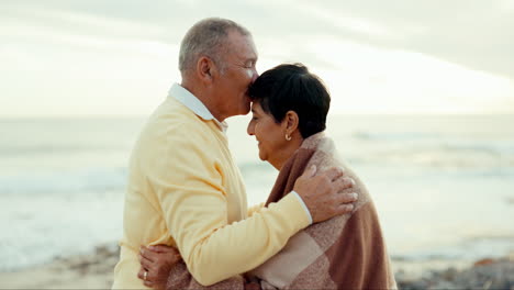 Senior-couple,-love-and-kiss-at-beach-for-care