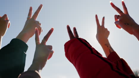 Peace-sign,-blue-sky-and-hands-of-friends