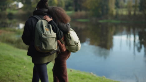 Couple-of-friends,-hug-or-walking-by-nature-lake