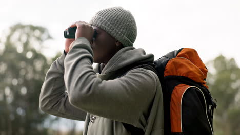 Black-man,-binoculars-and-backpack-in-travel-to