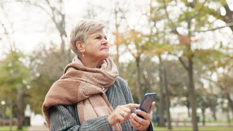 Phone,-navigation-and-a-senior-woman-in-the-park