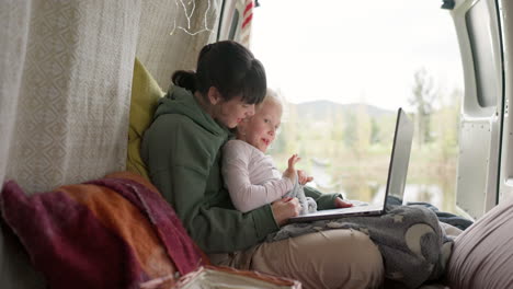 Mom,-girl-and-camping-holiday-with-laptop