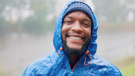 Face,-smile-and-a-black-man-hiking-in-the-rain