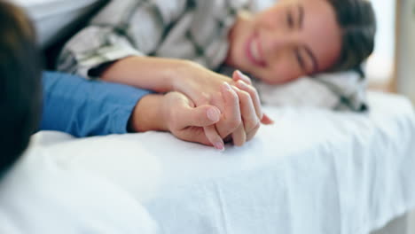 Love,-happy-and-couple-holding-hands-in-bed