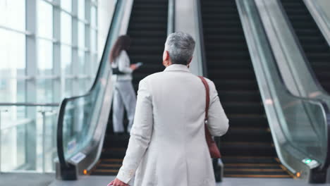 Escalator,-airport-and-business-woman-with-luggage