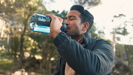 Man,-hiking-and-drink-from-water-bottle-in-outdoor