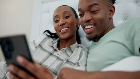 Love,-happy-and-black-couple-on-a-phone-in-bed