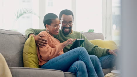 Couple,-hug-and-digital-tablet-on-sofa