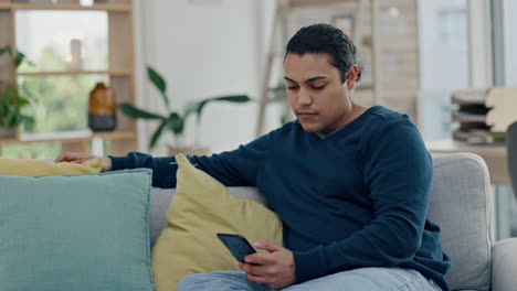Man,-relax-on-couch-and-smartphone