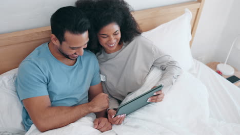 Tablet,-video-and-laughing-with-a-couple-in-bed