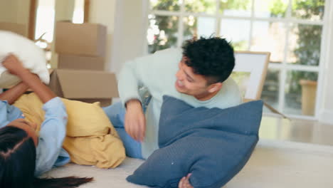Couple,-pillow-fight-and-floor-in-new-home