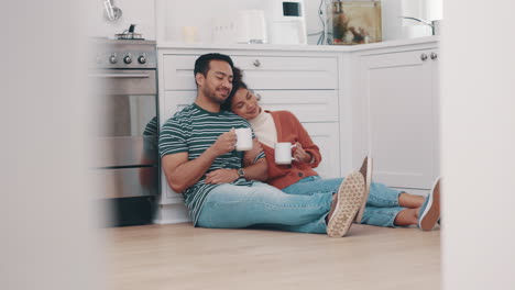 Drink,-coffee-and-couple-relax-in-kitchen-on-floor