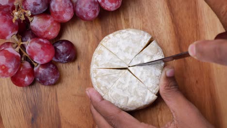 Fresh-goat-cheese-and-grape-fruit-on-wooden-background