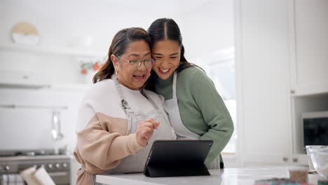 Tablet,-cooking-and-happy-with-senior-mother