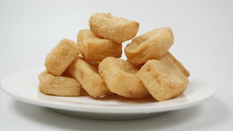 Stack-of-fried-tofu-on-a-plate-on-white-background-,