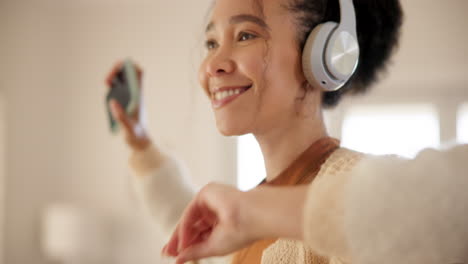Young-woman,-headphones-and-dancing-in-living